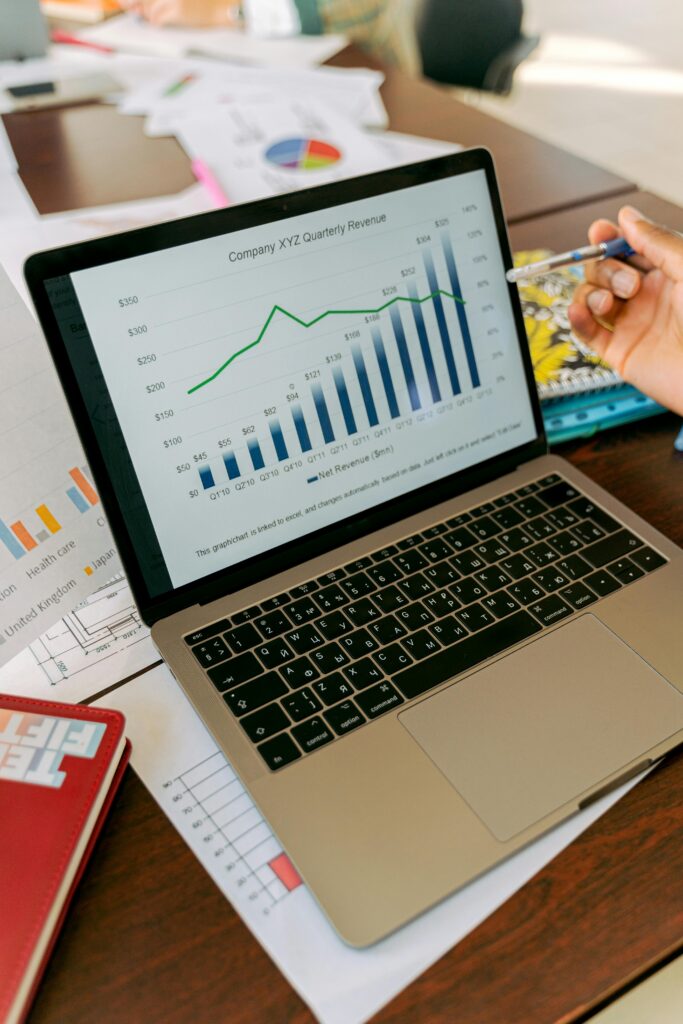 A close-up view of a laptop displaying business analytics and revenue charts.